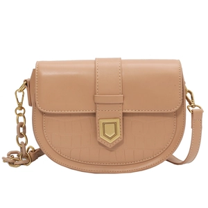 Pink faux leather saddle bag with crocodile texture and gold shield buckle closure