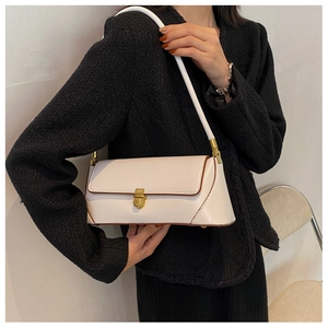 Detail of off-white baguette bag with gold metal buckle and brown edge oil process