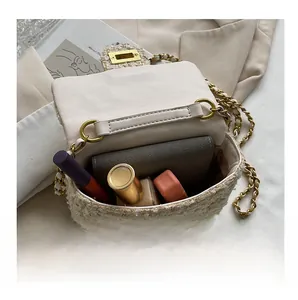 Internal view of beige tweed chain crossbody bag showing space for lipstick and wallet
