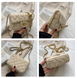 Detail view of beige tweed crossbody bag featuring a golden ball chain and twist lock