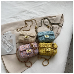 Detail of tweed mini chain bags with gold clasps and decorative ball shoulder straps