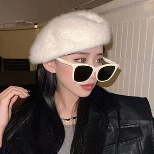 Fashionable beige oversized sunglasses paired with a white plush beret for a stylish look