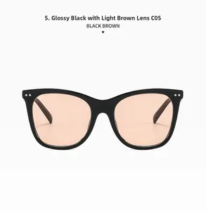 Detail view of cat-eye black frames sunglasses with light brown lenses and metal rivets