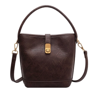 Vintage dark brown leather bucket bag with top handle and adjustable shoulder strap