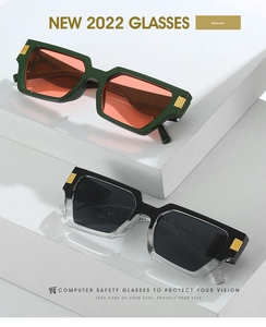 Detail of vintage thick frame sunglasses with metallic gold accents on geometric cubes