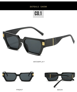 Detail view of black square sunglasses with crocodile leather texture and gold hardware