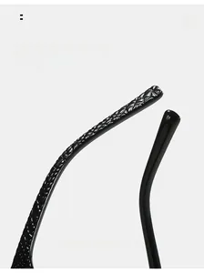 Detail of square sunglasses featuring curved temples with crocodile texture and smooth finish