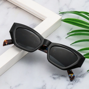 Detail of irregular tortoise shell temples on geometric black fashion sunglasses