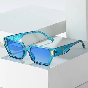 Square blue gradient sunglasses with alligator texture temples on a modern display