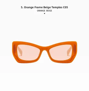 Detail of vintage cat-eye sunglasses with thick orange frames and beige temples