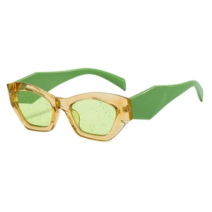 Retro cat-eye sunglasses with amber frames, green temples and glitter infused lenses