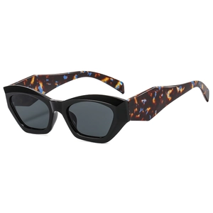 Chic cat-eye sunglasses featuring black thick frames and vibrant tortoiseshell temples