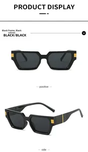 Detail view of black square sunglasses with gold hinges and crocodile textured temples