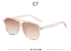 Detail view of champagne aviator sunglasses with brown gradient lenses and dual bridge