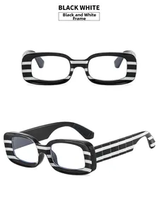 Close-up of retro black and white striped glasses frame with wide temples and clear lenses