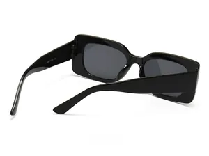 Detail view of the black rectangular sunglasses frame and temple with specs printing
