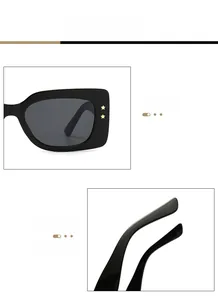 Close-up of black square sunglasses featuring star-shaped rivets and curved temples