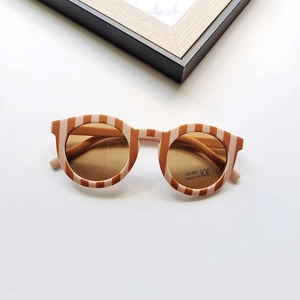 Close-up of retro striped kids sunglasses with UV400 protection and CE mark