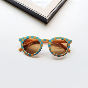 Detail of blue and yellow checkerboard kids sunglasses with UV400 protection lens