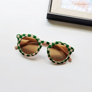 Macro shot of green checkerboard kids sunglasses with UV400 and CE protection markings