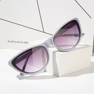 Cat eye sunglasses with light gray frame and purple gradient lenses on geometric stand