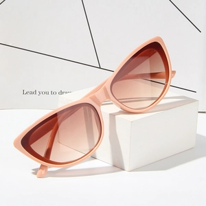 Retro cat-eye sunglasses with pink frames and gradient lenses on a minimalist stand