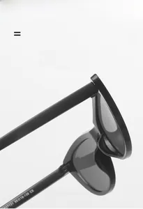 Close-up of flexible metal hinge and spec engraving on black cat-eye sunglasses