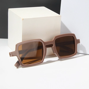 Square tortoise shell sunglasses with brown lenses on a modern minimalist background