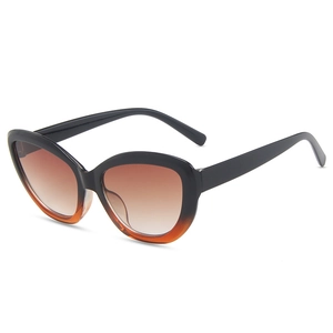 Vintage cat eye sunglasses with black and orange gradient frames and tinted lenses