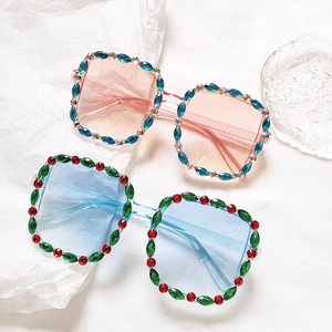 Kids square rhinestone sunglasses with pink and blue transparent lenses on white background