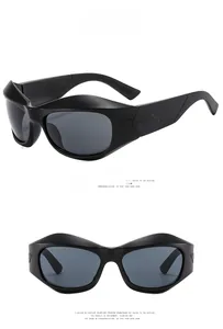 Detail of futuristic black Y2K sunglasses showing streamlined frame and matte finish