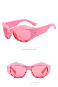 Detail view of pink Y2K futuristic sunglasses with bold frames and gradient lenses