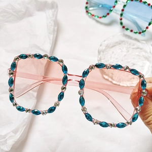 Kids square rhinestone sunglasses with pink transparent frame and sparkling blue crystals