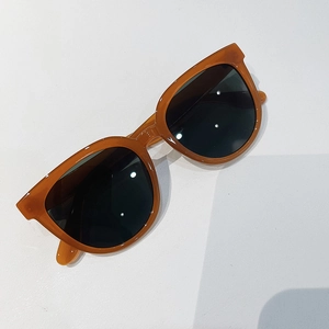 Detail of amber tortoiseshell transparent frame with dark UV lenses on vintage sunglasses