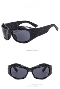 Detail of Y2K sunglasses featuring black frame with purple and cyan splatter paint