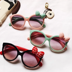 Three pairs of colorful bow-knot kids sunglasses with round frames and gradient lenses