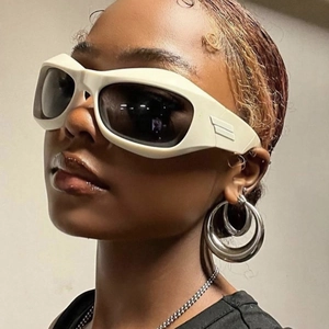 Futuristic Y2K cream white wrap-around sunglasses and silver layered hoop earrings