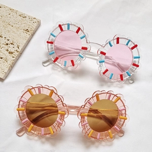 Cartoon flower shaped sunglasses for kids in pink and amber candy jelly colors