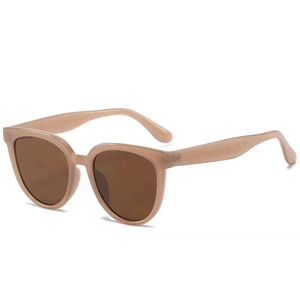 Vintage retro oversized beige sunglasses with dark brown lenses on white background