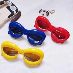 Kids cool cat-eye sunglasses in bright blue red and yellow with thick round frames