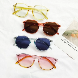 Set of four retro gradient blush glasses in assorted colors on a soft white cloth background