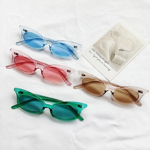 Collection of cat-eye sunglasses in transparent blue, pink, brown, and green colors