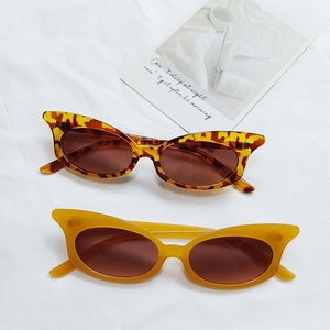 Retro cat-eye sunglasses in leopard print and yellow on elegant white fabric