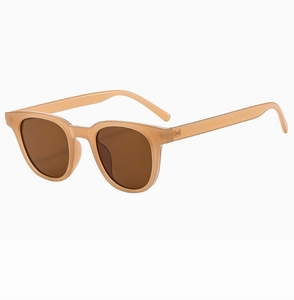 Close-up of retro square sunglasses with translucent peach frames and brown UV lenses