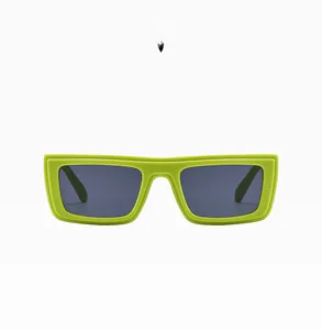 Detail view of bold green rectangular resin sunglasses with dark UV protection lenses