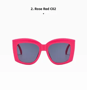 Detail view of oversized rose red resin sunglasses with dark grey lenses in C02 color