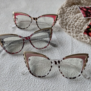 Detailed view of three cat-eye glasses with leopard patterns and metal top frames