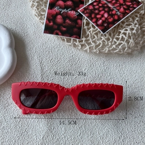 Modern rectangular red sunglasses with textured frames and dark UV protection lenses
