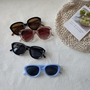 Retro oversized round sunglasses in multiple colors on a textured white background