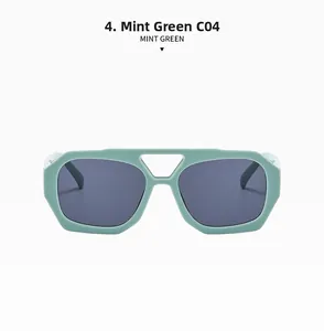 Detail view of mint green geometric sunglasses with a double bridge and grey lenses